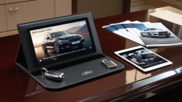 A premium video mailer displaying a car model launch video, lying on a showroom desk with broc...jpg