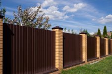 brown-metal-fence-with-brick-posts-against-blue-sky_156745-838.jpg